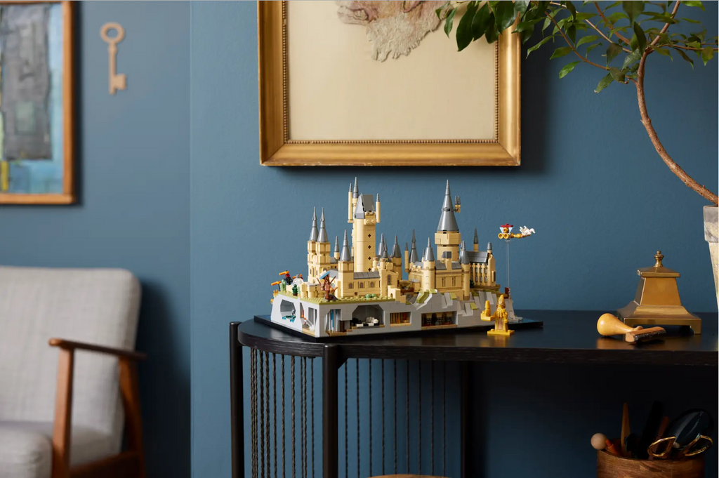 LEGO Harry Potter Hogwarts Castle and Grounds set displayed on a table, showcasing intricate castle details and mini figures.